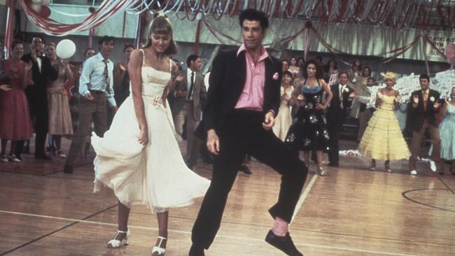 Olivia Newton-John and John Travolta dance in a crowded high school gym in a still from 'Grease', 1978. Picture: Getty Images.