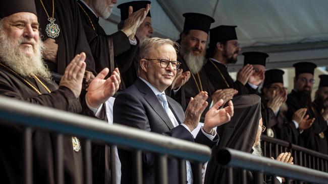 Anthony Albanese stands among Greek Orthodox clergy at Kia Arena in Melbourne on Sunday. Picture: NewsWire/Tamati Smith.