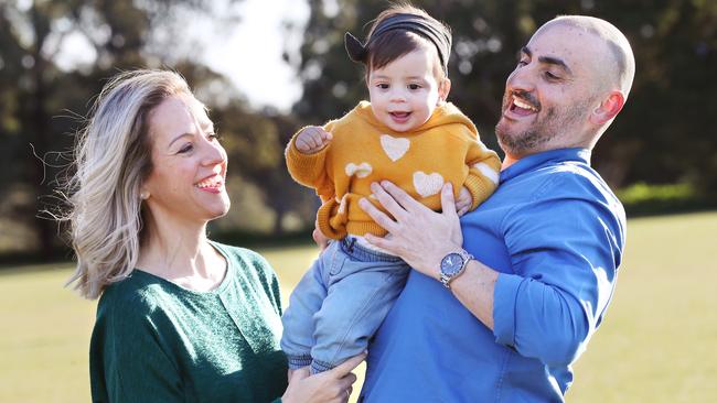 Mary, Angelo and 10-month-old Annabelle playing in a park at Thornbury. Picture Rebecca Michael