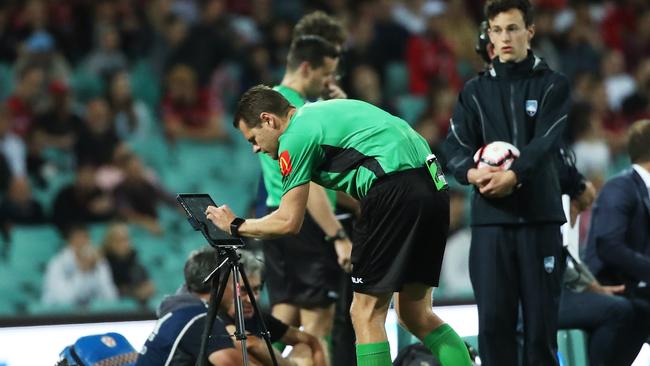 A-League referee Chris Beath checks a VAR goal review. Picture: Phil Hillyard.