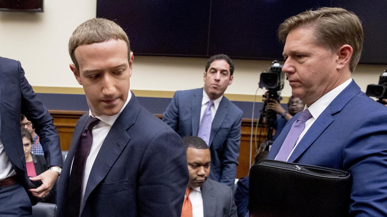Facebook CEO Mark Zuckerberg accompanied by Facebook vice president for U.S. public policy, Kevin Martin (right).