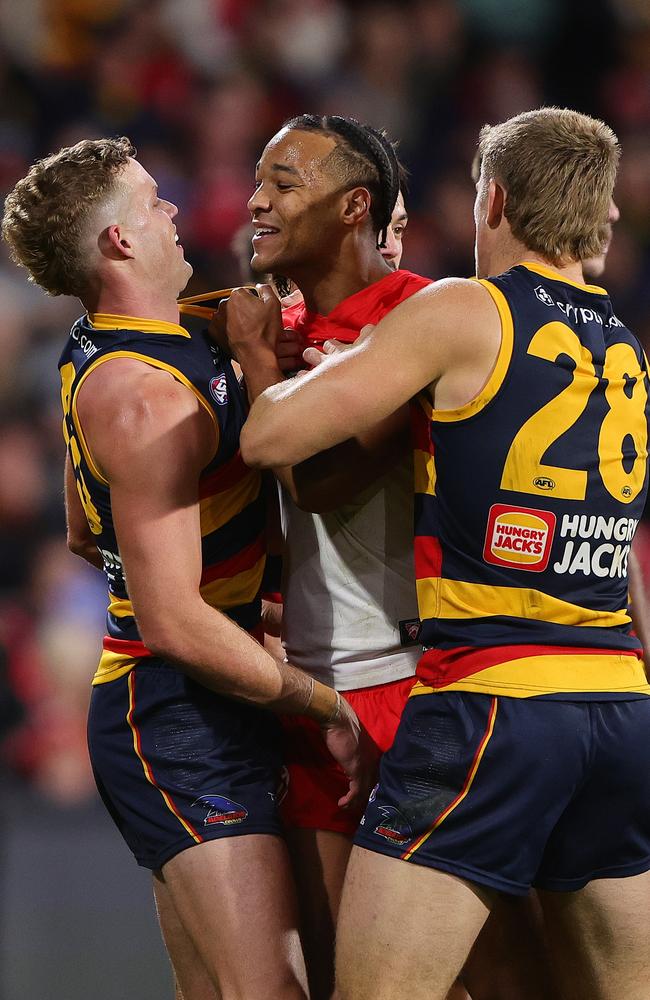 Joel Amartey of the Swans remonstrates with Mitchell Hingeand Nick Murray after kicking one of his nine goals on Saturday. Picture: Sarah Reed/AFL Photos via Getty Images.