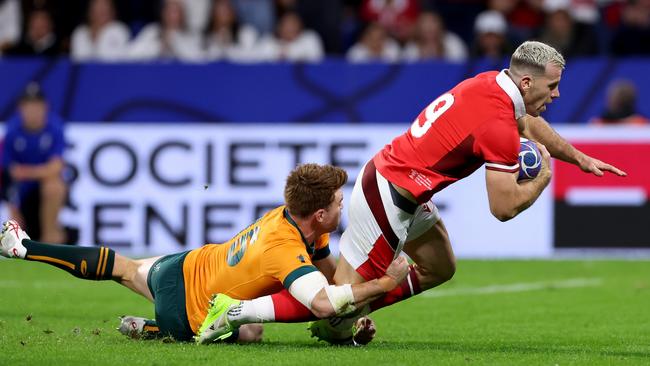 Wales scrumhalf Gareth Davies breaks through the tackle of Andrew Kellaway to score his team's first try. Picture: Getty Images