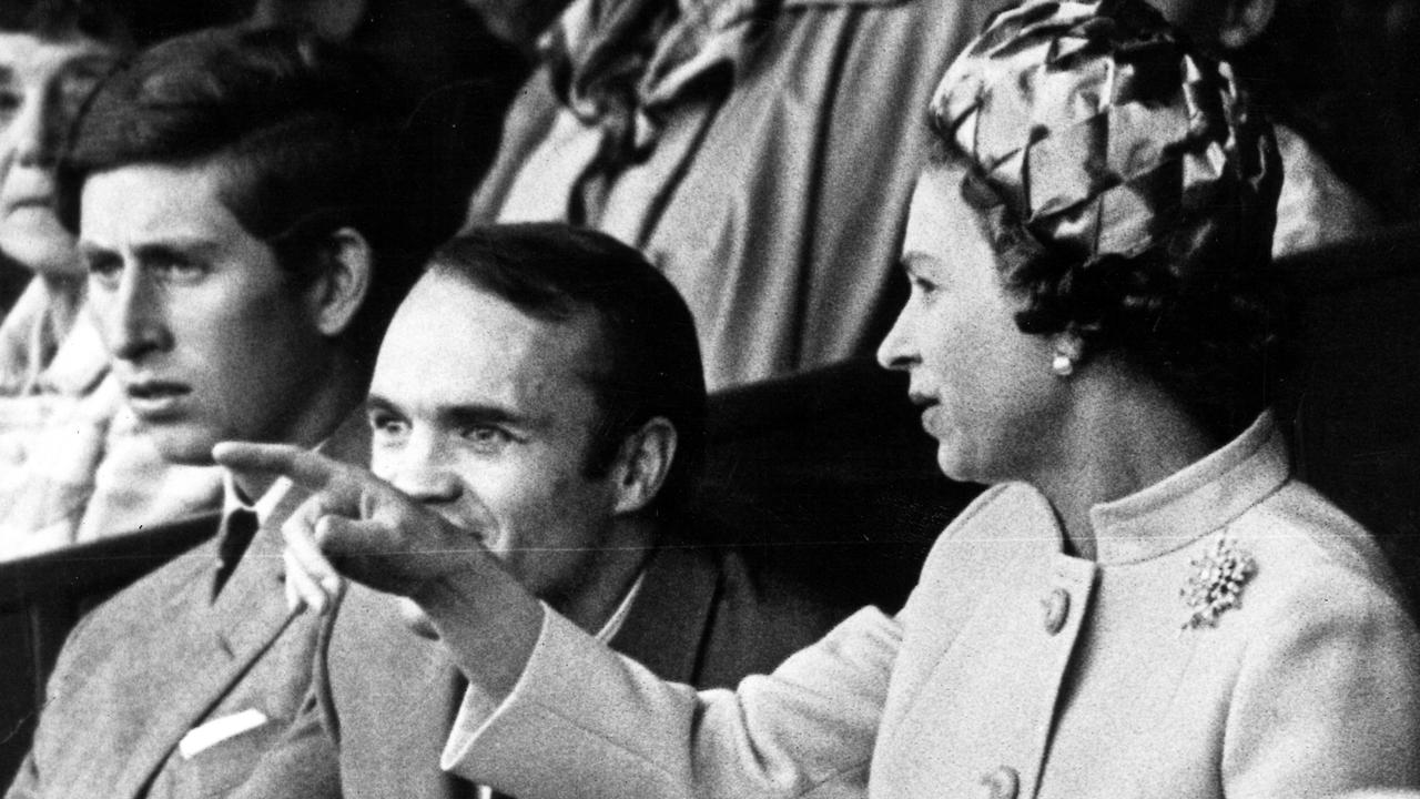 Ross Smith sits between Queen Elizabeth II and Prince Charles in 1970.