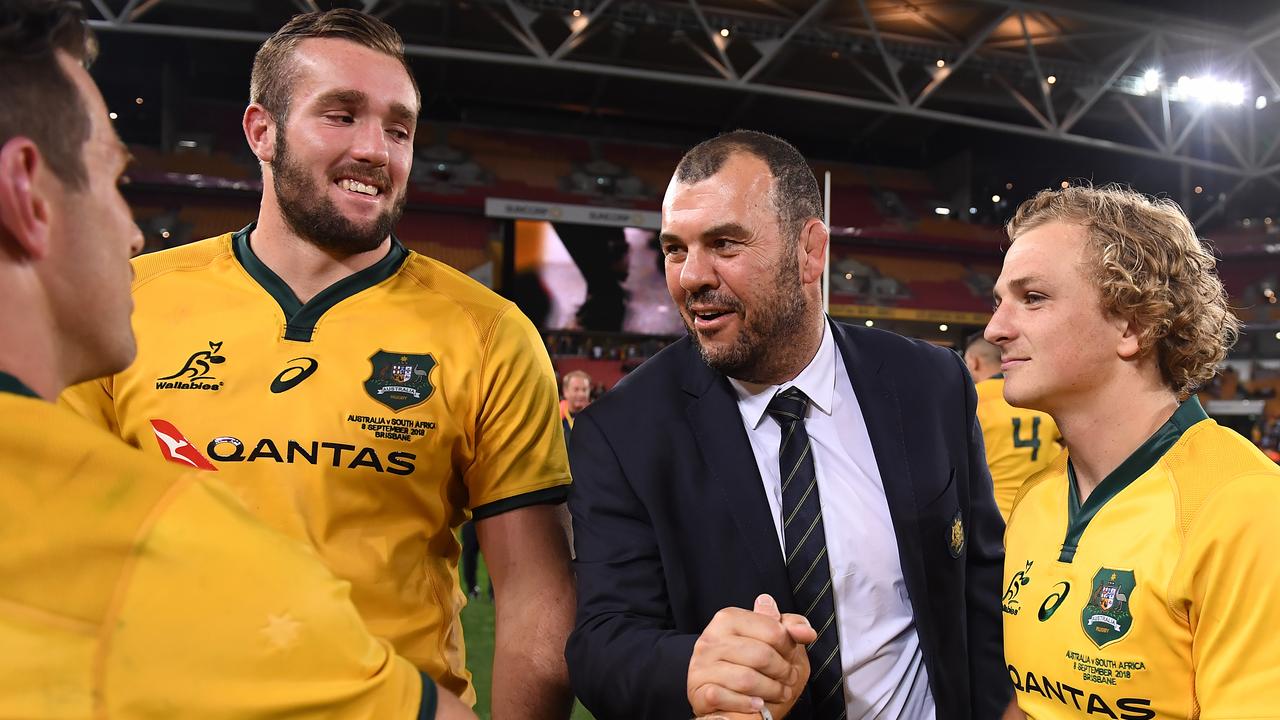 Wallabies coach Michael Cheika celebrates with his players after holding on to beat the Springboks.