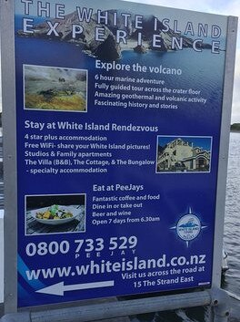 A sign on Whakatane wharf advertises the volcano experience.