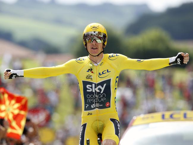 Britain's Geraint Thomas, wearing the overall leader's yellow jersey reacts as he crosses the finish line during the twentieth stage of the Tour de France cycling race.