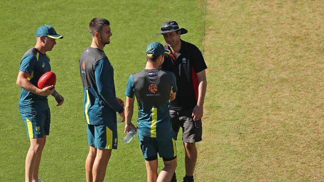 MCG groundsman Matt Page talks with Marcus Harris, Mitch Marsh and Travis Head as they inspect the pitch. Picture: Getty