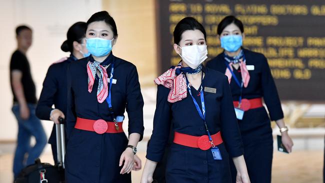 China Eastern Airlines cabin crew wear protective face masks at Brisbane International Airport.