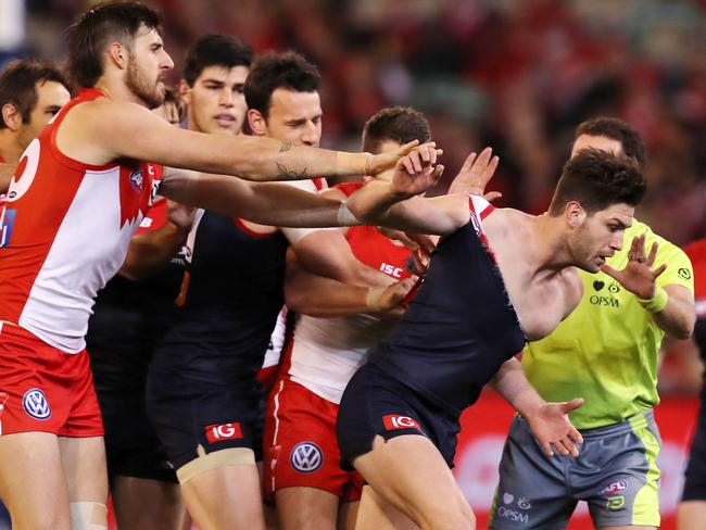 AFL Round 15. Melbourne vs. Sydney Swans at the MCG. Swans players remonstrate with Melbourne's Tomas Bugg after an off the ball incident with Callum Mills   . Pic: Michael Klein