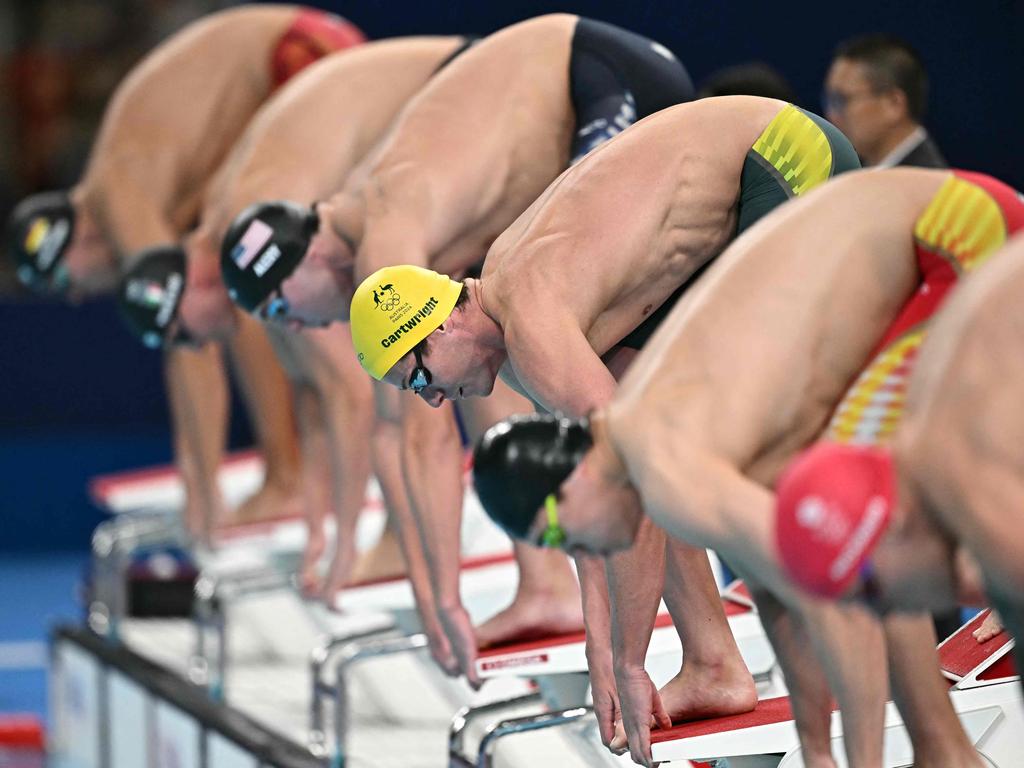 Australia's Jack Cartwright (centre) prepares to compete in the final of the men's 4x100m freestyle relay, 2024. (Photo by Manan VATSYAYANA/AFP)