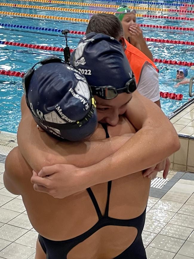 The Martin sisters of St Margaret's embrace moments after they won their respective events.