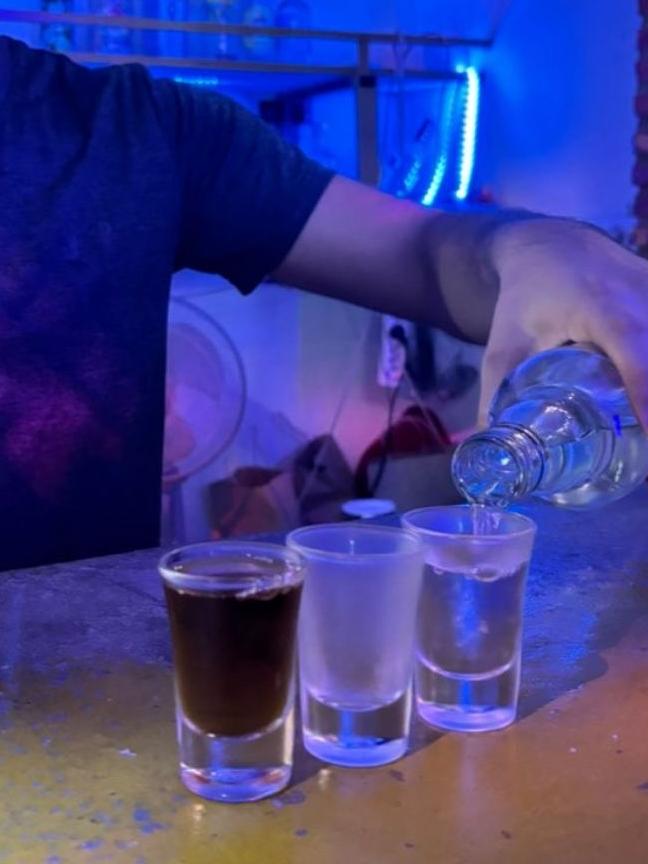 An image of the free Tiger whisky and vodka shots being served at the Nana Backpackers in Laos when six tourists were killed by methanol poisoning.