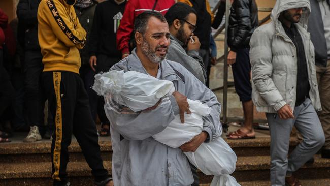 A man carries the body of his child. Picture: Ahmad Hasaballah