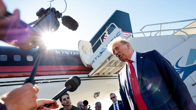 Donald Trump speaks to members of the media as he arrives at Philadelphia International Airport.