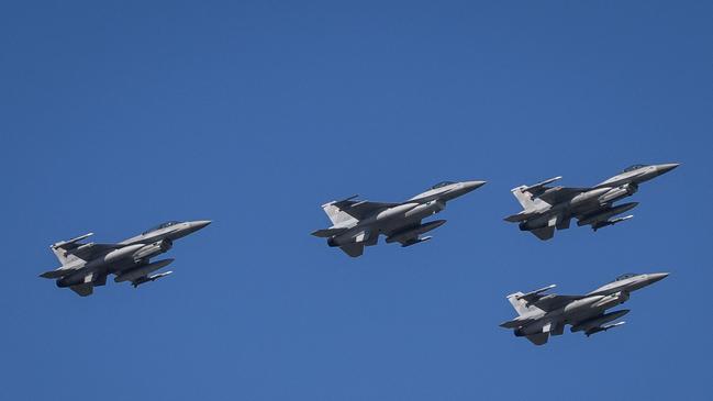 Polish Air Force F-16 fighters, of the type that will go to Ukraine, conduct a fly past during a military parade in Warsaw this week. Picture: AFP