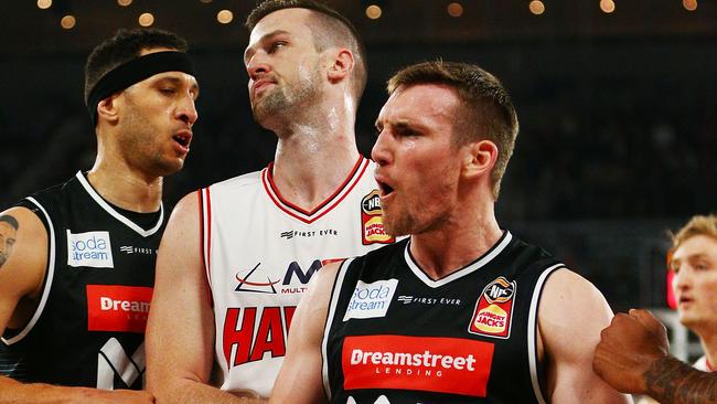 MELBOURNE, AUSTRALIA — OCTOBER 29: Mitch McCarron of United celebrates a basket as AJ Ogilvy of the Hawks reacts during the round three NBL match between Melbourne United and the Illawarra Hawks at Melbourne Arena on October 29, 2018 in Melbourne, Australia. (Photo by Michael Dodge/Getty Images)