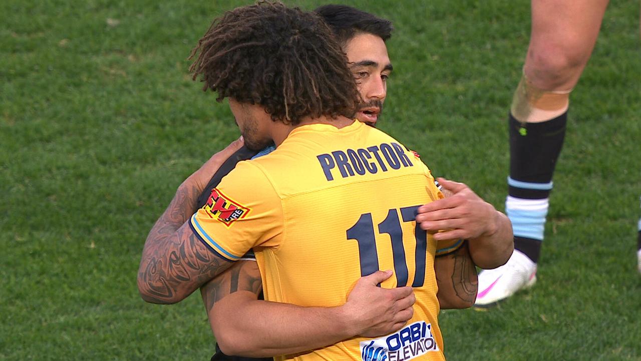 Kevin Proctor and Shaun Johnson embrace.