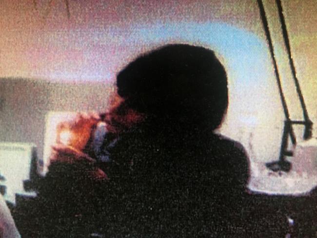 Police evidence image taken from a computer screen showing Harriet Wran smoking an Ice Pipe.