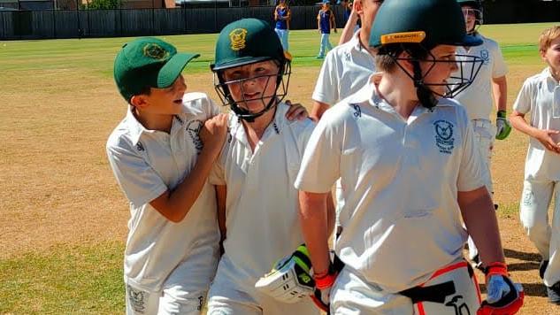 Ieuan (centre) on-field with his teammates before being banned. Picture: Supplied