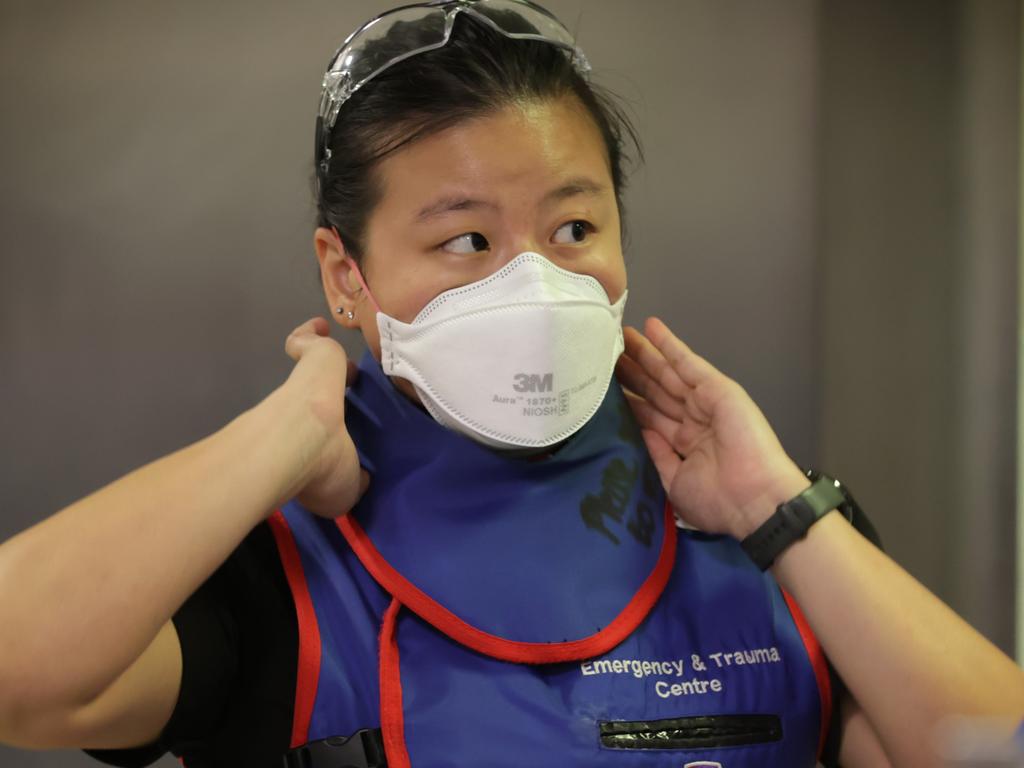 Dr Faith Tan puts on radiation protection clothing for X-rays. Picture: David Caird