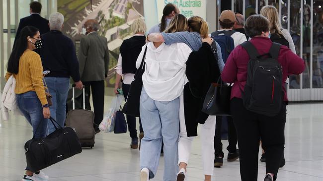 People reuniting at Adelaide Airport on the first day of the border opening. Picture: David Mariuz