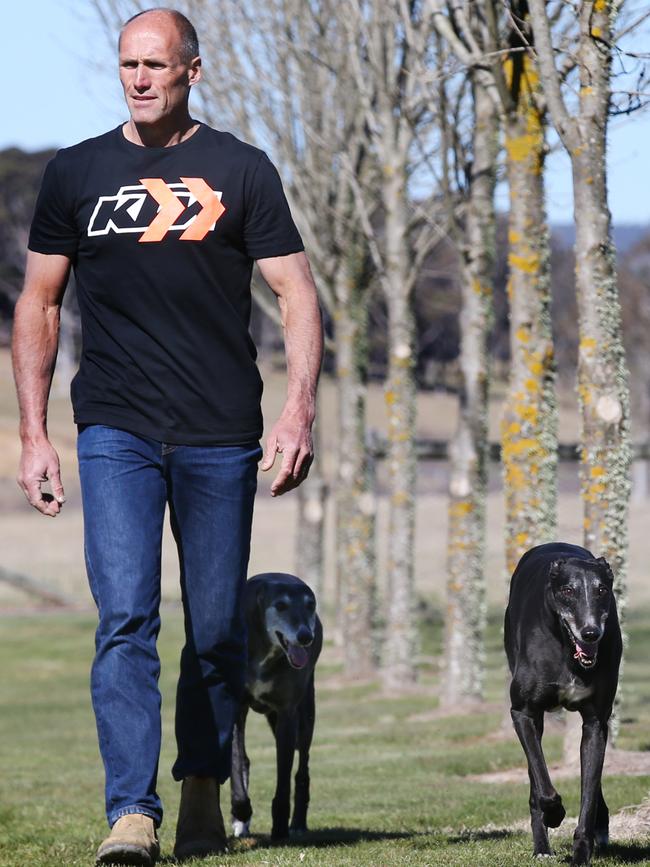 Tony Lockett walking with his champion greyhounds Bon and Yogi. Picture: Michael Klein