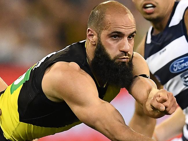 MELBOURNE, AUSTRALIA - SEPTEMBER 20: Bachar Houli of the Tigers handballs whilst being tackled by Rhys Stanley of the Cats during the AFL Preliminary Final match between the Richmond Tigers and the Geelong Cats at Melbourne Cricket Ground on September 20, 2019 in Melbourne, Australia. (Photo by Quinn Rooney/Getty Images)