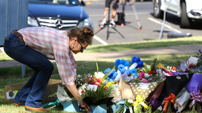 Chinchilla florist Erin Ford lays flowers at Chinchilla Police Station in memory of fallen officers. Picture David Clark NCA/NewsWire