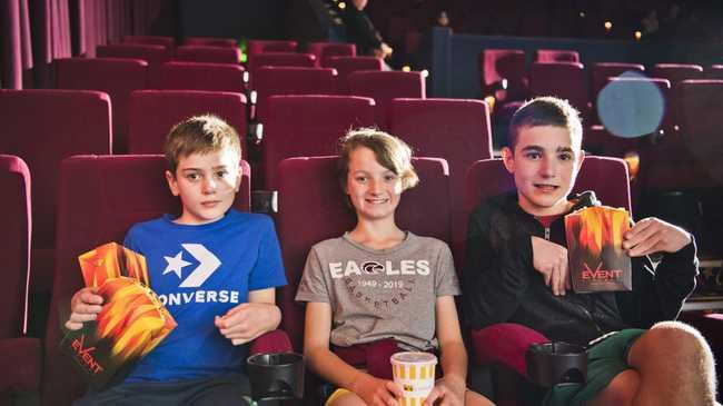 Phoenix Taylor, Hudson Strong and Taj Taylor found the front seats for their first trip to the movies for a long time. Picture: Nev Madsen