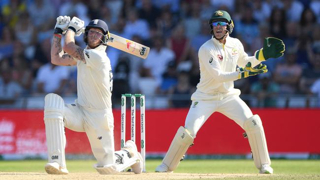 England batsman Ben Stokes hits a ball for 6 runs watched by Tim Paine during day four of the 3rd Ashes Test Match. Picture: Getty