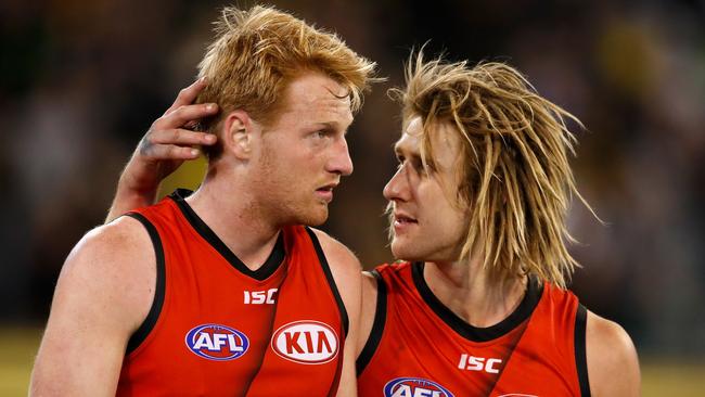 Francis gets some advice from Essendon captain Dyson Heppell. Picture: AFL Media/Getty Images