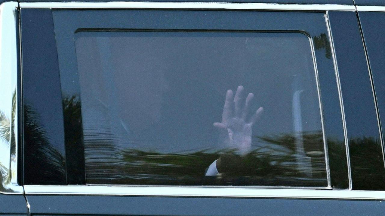 Mr Trump waves as he leaves his Florida home ahead of New York trip. Picture: Chandan Khanna/AFP