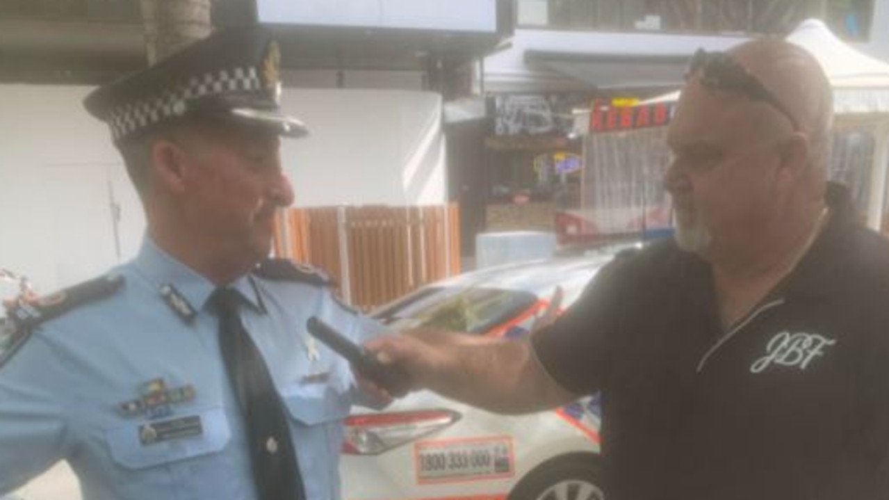 Brett Beasley wands Acting Assistant Commissioner Rhys Wildman in Surfers Paradise. Picture: Greg Stolz