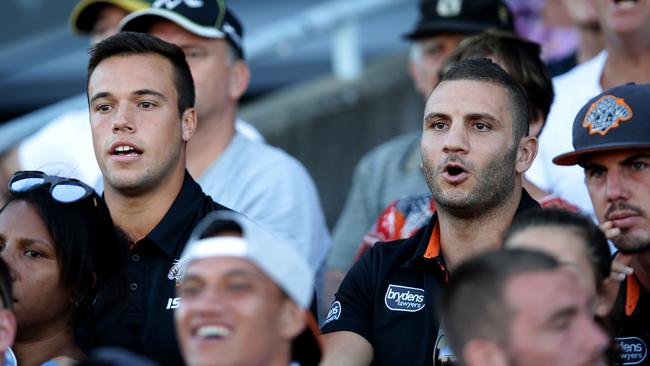 Luke Brooks and Robbie Farah watch from the stands.