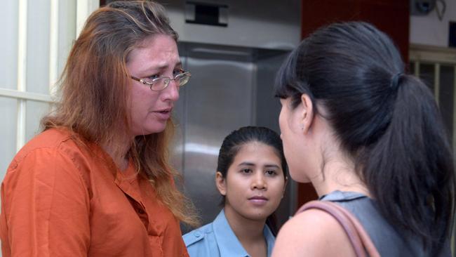 Australian woman Yoshe Ann Taylor (left) cries as she speaks to an official of the Australia Embassy at the Phnom Penh municipal court. Picture: AFP