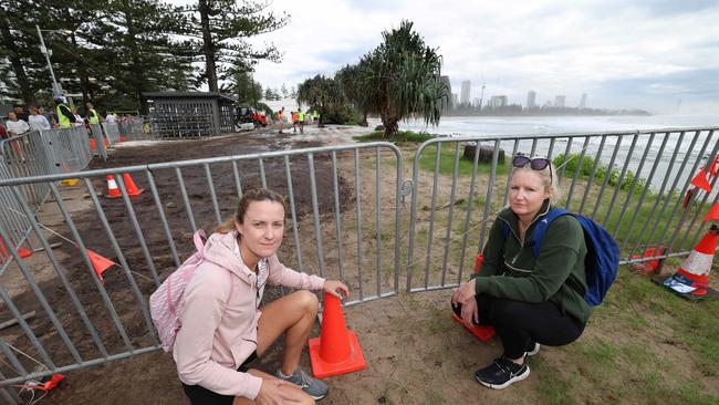 Jackie Parra and Anna Tillotson react to the ‘stinking mud pit’ after they remove mats at Burleigh Hill. Pic Annette Dew