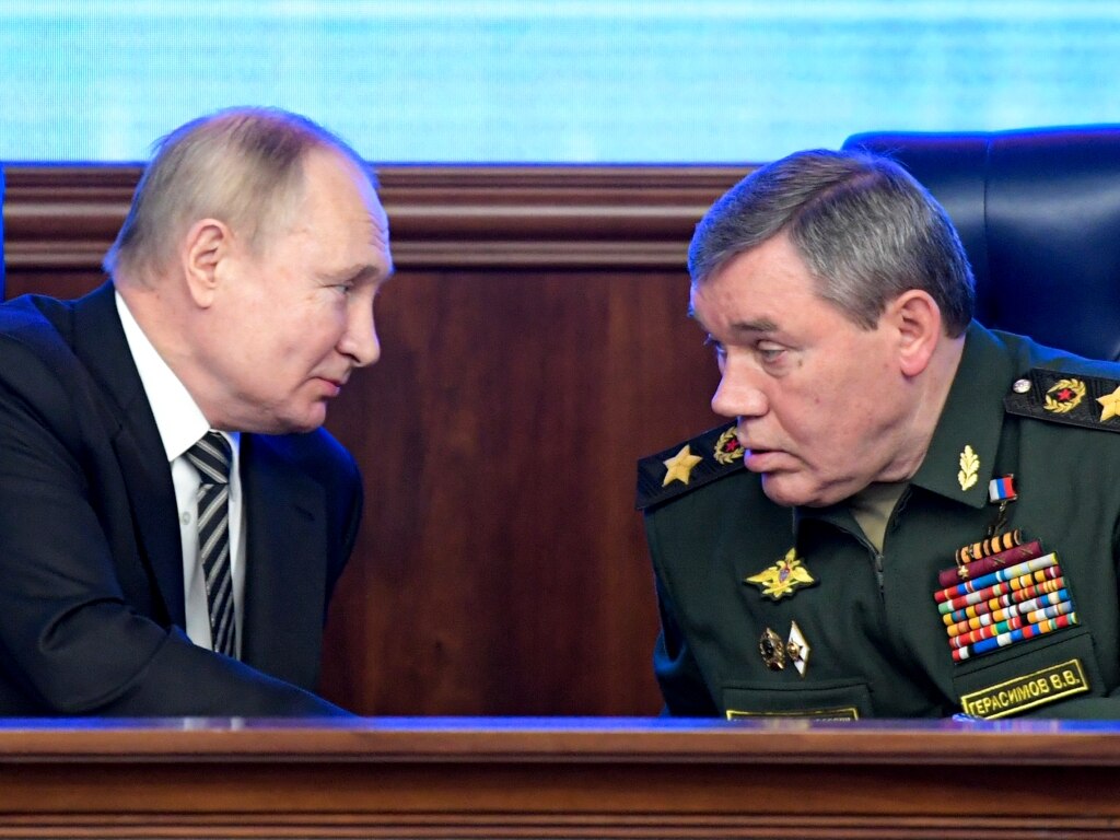 FILE - Russian President Vladimir Put, left, and Russian General Staff Valery Gerasimov talk to each other during a meeting in Moscow, Russia on Dec. 21, 2021. Putin has put Gerasimov directly in charge of Russian forces in Ukraine, a move that some observers saw as an attempt to curtail the influence of Yevgeny Prigozhin, the millionaire owner of the Wagner Group private military company who has publicly criticized the top military brass. (Sputnik, Kremlin Pool Photo via AP, File)