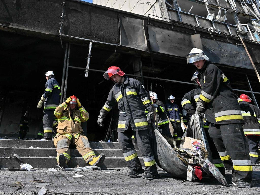 Firefighters remove rubble from a damaged building following a Russian air strike in the city of Vinnytsia, west-central Ukraine, on July 14, 2022. Picture: Sergei Supinsky / AFP.