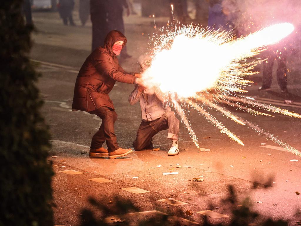 Two protesters launch fireworks towards the police. Picture: Giorgi ARJEVANIDZE / AFP