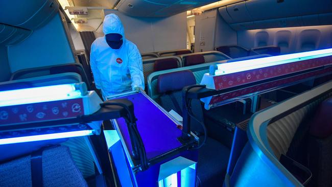 Ultraviolet light robots, like this one at work in an aircraft, are being used to clean offices.