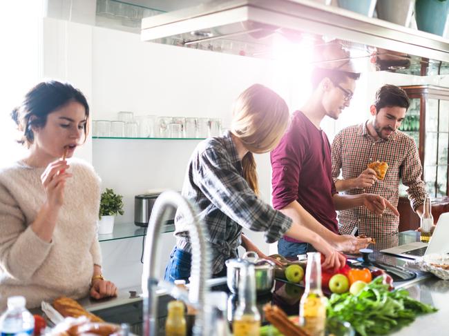 Leader Hot Topic - to share or not to share - sharehouse, share house living - real estate - Peter Koulizos - iStock-531184054 group of friends eating on the kitchen for the party