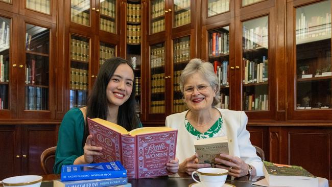 18-year-old student Mia Ohara Ngo, the 2025 Tennyson Medal recipient, with a selection of favourite books, with Her Excellency the Honourable Frances Adamson AC, Governor of South Australia, in the Government House library. Picture: Kelly Barnes