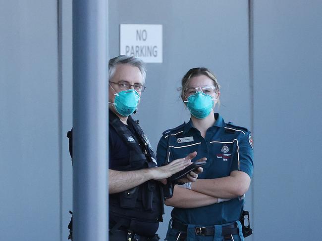 Ambulance and police in PPE and masks at the Novotel Brisbane Airport. Picture: Liam Kidston