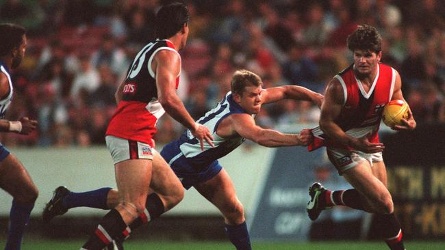 Robert Harvey gets away from North Melbourne’s Glenn Archer in 1998..