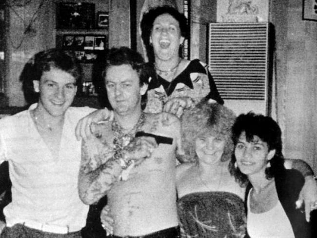 Dennis Allen playfully points a pistol at the head of his mother Kath Pettingill at a party in one of Dennis' houses. Picture: News Corp