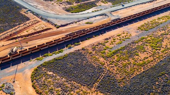 Freight wagons filled with iron ore travel along rail tracks in this aerial photograph taken near Port Hedland, Australia, on Wednesday, March 20, 2019. Photo: Ian Waldie