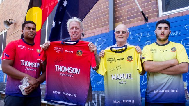 Jeff Thomson and classmate Garry Manuel with their house jerseys presented by sports captains Elijah Rokolaqa, right, and Sohibe El-Ahmad. Picture: Francis Floresca