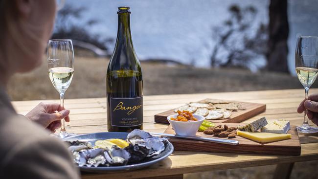 TAS WEEKEND: Couple, Ange Boxall and Mike Travalia on a Tasmanian Air Tours helicopter tour to Tasman Peninsula property, Bangor. Enjoying locally sourced oysters, cheese and Bangor sparkling wine.