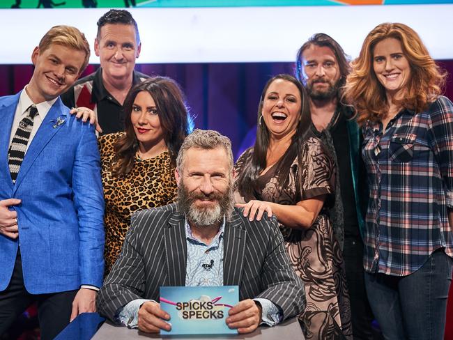 Spicks and Specks host Adam Hills, centre, with Joel Creasey, Alan Brough, Ella Hooper, Myf Warhust, Nic Ceste and Sarah Kendall. Picture: Supplied by ABC-TV.